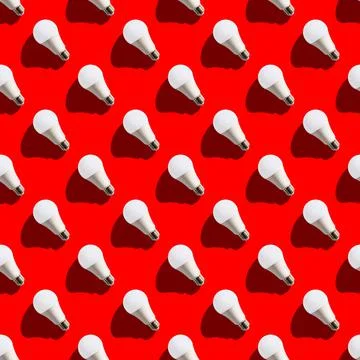 Seamless pattern. white lightbulbs is left up on red background. geometric ar Stock Photos