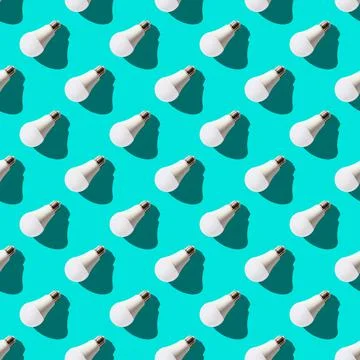 Seamless pattern. white lightbulbs is left down on turquoise background. geom Stock Photos