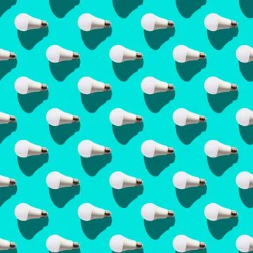 Seamless pattern. white lightbulbs is left on turquoise background. geometric Stock Photos