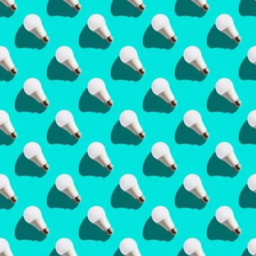 Seamless pattern. white lightbulbs is left up on turquoise background. geomet Stock Photos