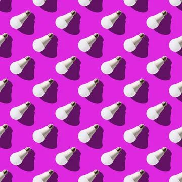 Seamless pattern. white lightbulbs is left down on violet background. geometr Stock Photos