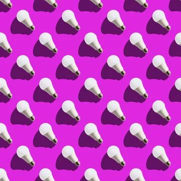Seamless pattern. white lightbulbs is left up on violet background. geometric Stock Photos