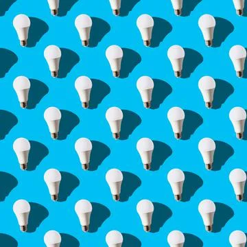 Seamless pattern. white lightbulbs is up on light blue background. geometric  Stock Photos