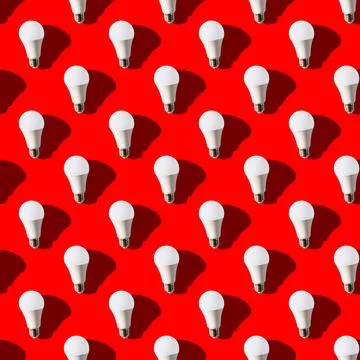 Seamless pattern. white lightbulbs is up on red background. geometric arrange Stock Illustration