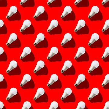 Seamless pattern. white lightbulbs is right up on red background. geometric a Stock Illustration