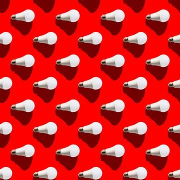 Seamless pattern. white lightbulbs is right on red background. geometric arra Stock Illustration
