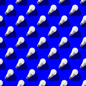 Seamless pattern. white lightbulbs is right up on dark blue background. geome Stock Photos
