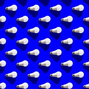 Seamless pattern. white lightbulbs is right on dark blue background. geometri Stock Photos