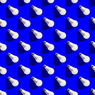 Seamless pattern. white lightbulbs is right down on dark blue background. geo Stock Photos