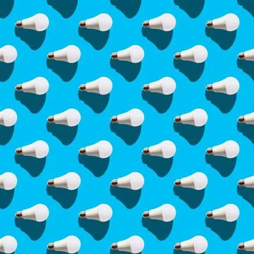 Seamless pattern. white lightbulbs is right on light blue background. geometr Stock Photos