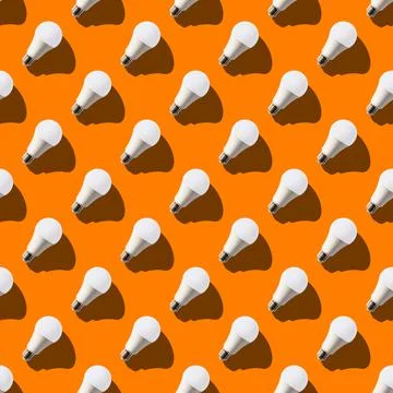 Seamless pattern. white lightbulbs is right up on orange background. geometri Stock Photos