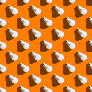 Seamless pattern. white lightbulbs is right down on orange background. geomet Stock Photos