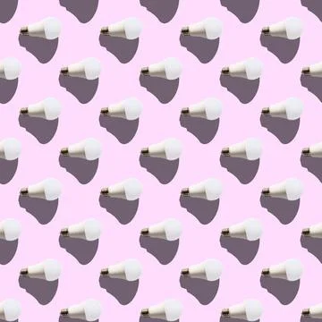 Seamless pattern. white lightbulbs is right on pink background. geometric arr Stock Photos