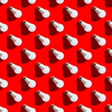 Seamless pattern. white lightbulbs is right down on red background. geometric Stock Photos
