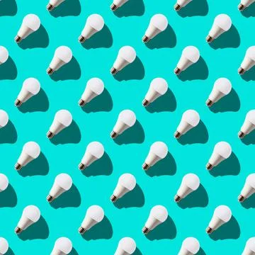Seamless pattern. white lightbulbs is right up on turquoise background. geome Stock Photos