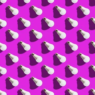 Seamless pattern. white lightbulbs is right down on violet background. geomet Stock Photos