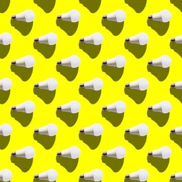 Seamless pattern. white lightbulbs is right on yellow background. geometric a Stock Photos