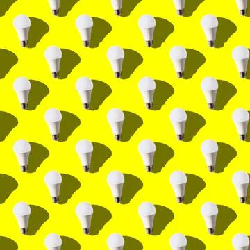 Seamless pattern. white lightbulbs is up on yellow background. geometric arra Stock Photos