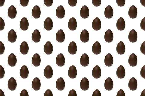 Seamless pattern of whole chocolate Easter eggs on a white background. Easter Stock Photos