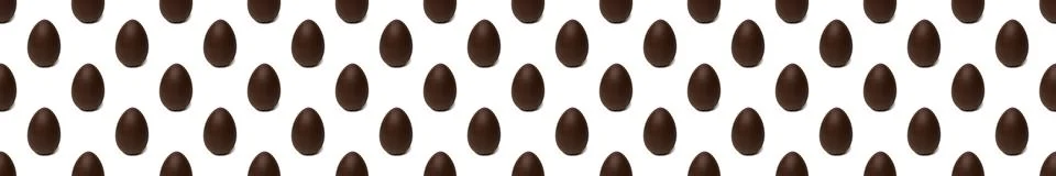 Seamless pattern of whole chocolate Easter eggs on a white background. Easter 스톡 사진