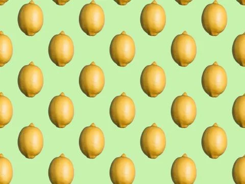 Seamless pattern of whole lemons on mint green background. Flat lay, top view. Stock Photos