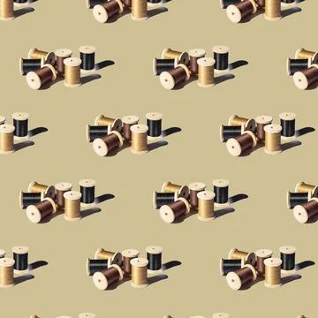 Seamless pattern of wooden spools with threads of different colors Stock Photos