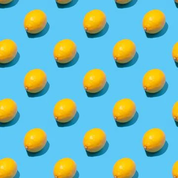 Seamless pattern with yellow lemons on a blue background Stock Photos