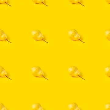Seamless pattern of yellow ripe pears on a bright yellow background. Stock Photos