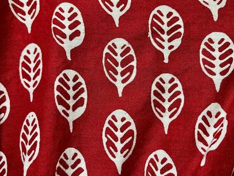 Seamless red fabric background texture featuring abstract white leaf block Stock Photos