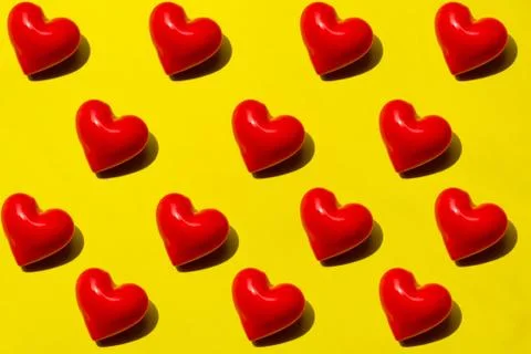 Seamless Red hearts pattern on yellow background. Top view, flat lay, layout Stock Photos