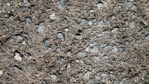 Seamless rotating loop of a dark asphalt road surface texture, featuring ro.. Stock Footage 343512179