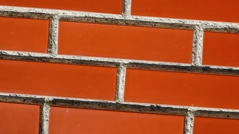 Seamless rotating loop of a glossy orange ceramic brick wall texture with t.. Stock Footage 343514591