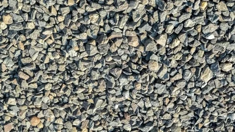 Seamless rotating loop of a natural grey crushed gravel stone aggregate sur.. Stock-Footage 343513579