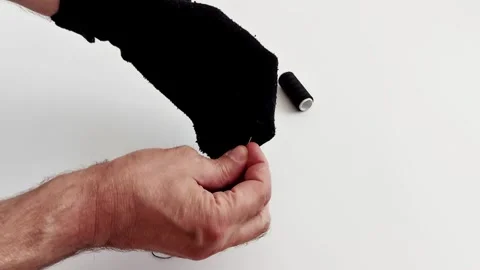 Seamless Sock Repair: Quick Needle Thread Fix Stock Footage 310822919