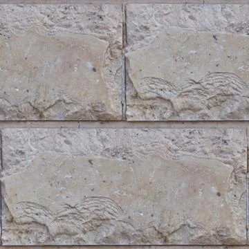 Seamless soft focus texture of decorative concrete wall from bricks. Stock Photos