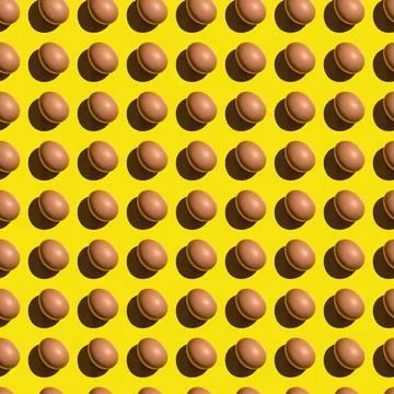 Seamless texture background pattern from eggs on a colored background. Minima 库存照片