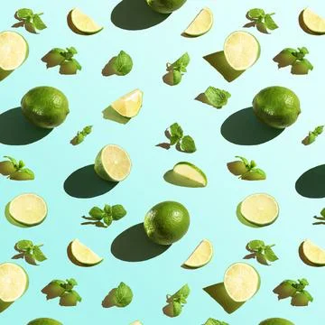 Seamless texture of lime with mint on a blue background. Top view. Stock Photos
