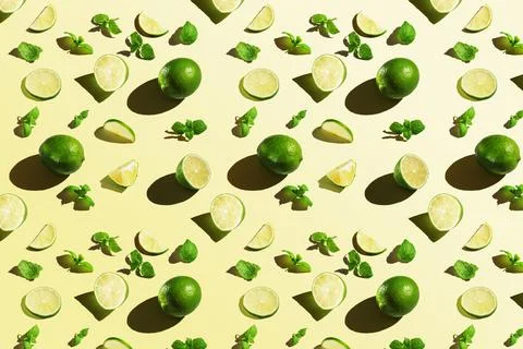 Seamless texture of lime with mint on yellow background. Top view. Stock Photos