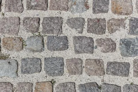 Seamless texture of old square stone pavement with big gaps between. Stock Photos