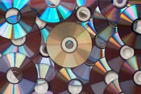 A seamless texture of shiny compact discs arranged closely together, creating Stock Photos
