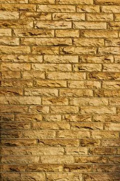 Seamless texture of a yellow brick wall, perfect for background or pattern .. Stock Photos