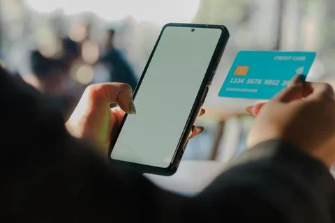Seamless Transactions: Making a Digital Purchase with Phone and Card Stock Photos