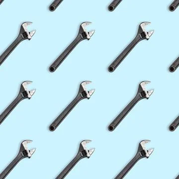 Seamless wrench pattern on light blue background. Repair service concept Stock Photos