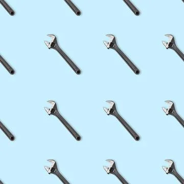 Seamless wrench pattern on light blue background. Repair service concept Stock Photos