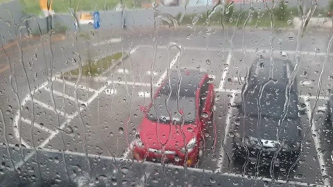 Seamlessly Looping Drops Of Rain On A Window Pane, Parking Area In Background. Stock Footage 183913229