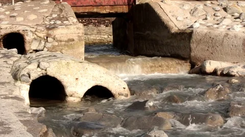 A Seamlessly Looping Small Waterfall Under a Bridge Video stock 85423499