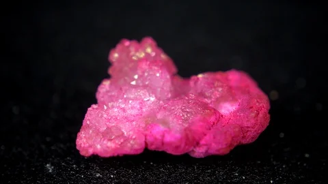 Seamlessly rotating a hearth shaped pink ore in front of black background Stock Footage 104329733