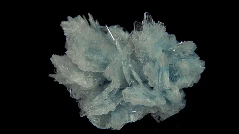 Seamlessly rotating a light blue mineral (Baryte) in front of black background Stock Footage 104593255
