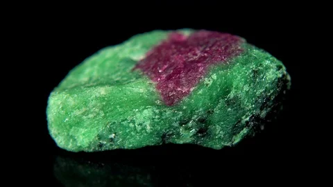 Seamlessly rotating a mineral (Rubin) in front of black background Stock Footage 104593232