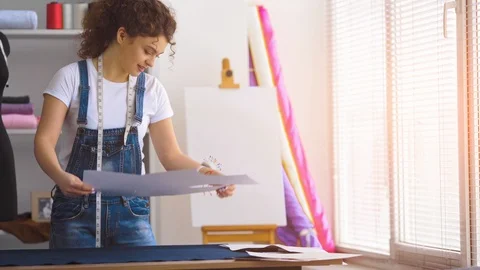The seamstress in atelier working with a textile on the table Stock Footage 107653584